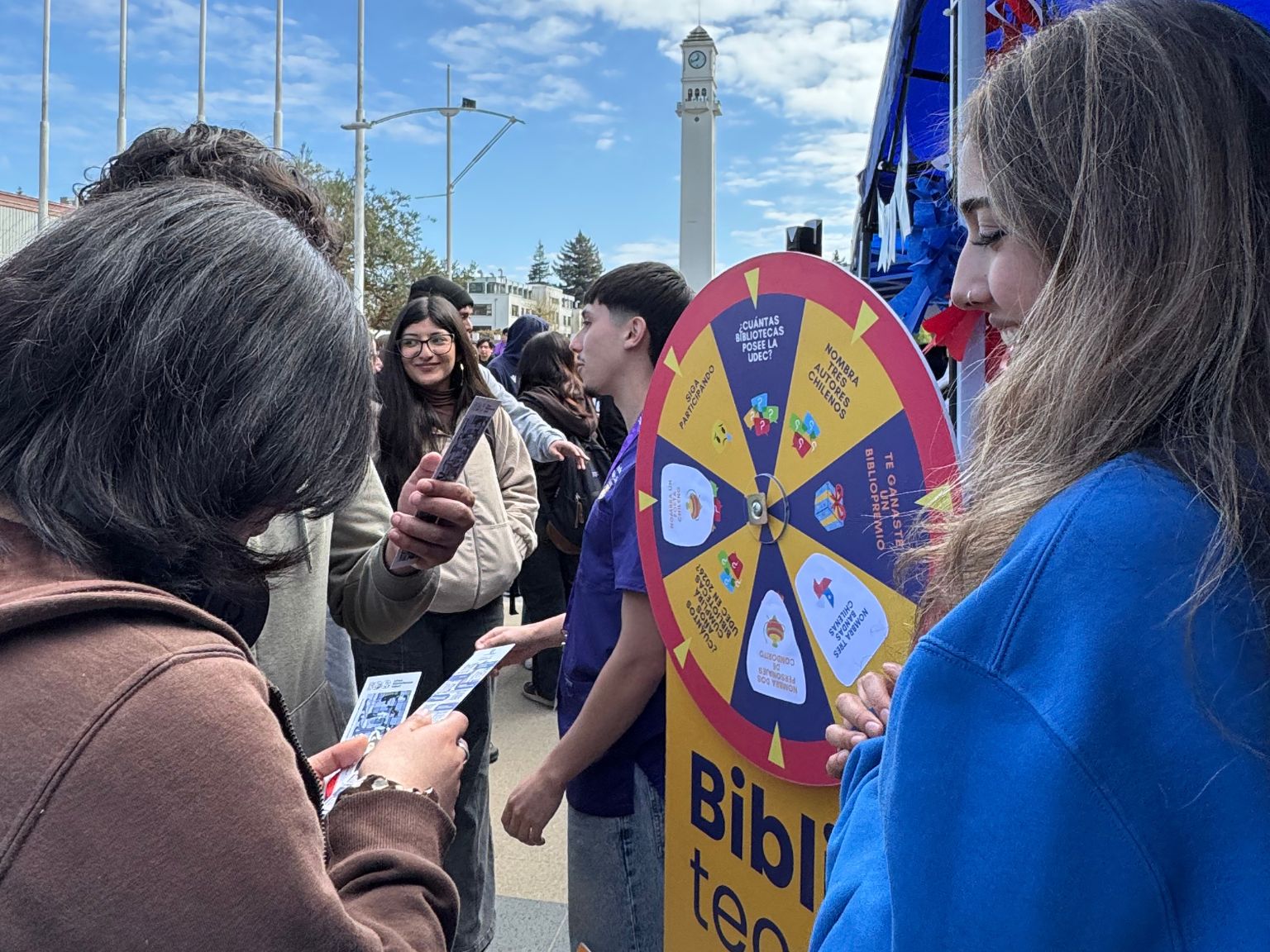 Estudiantes juegan a la ruleta en stand de Bibliotecas UdeC